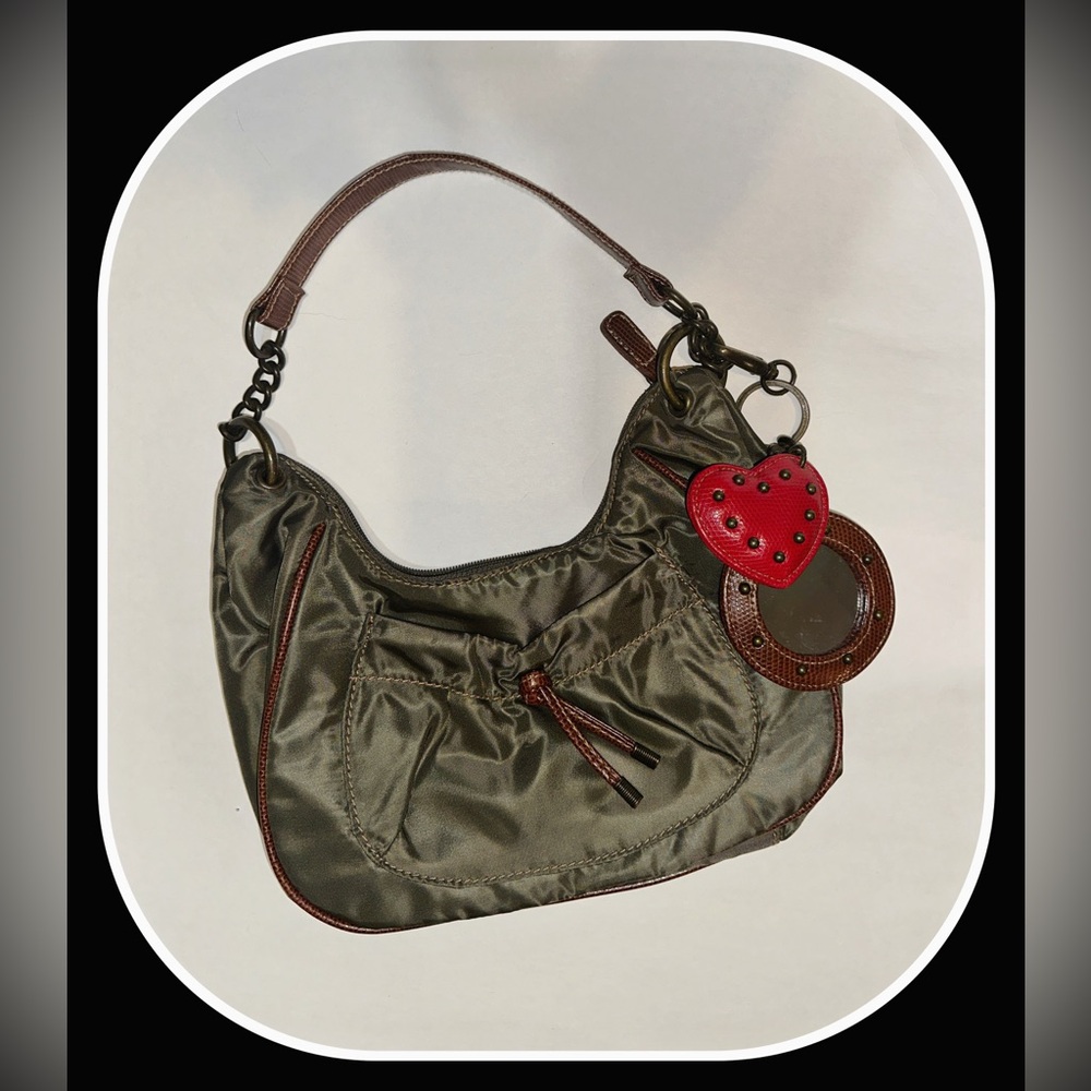Adorable hobo-style olive green shoulder bag with mirror and heart bag charms.